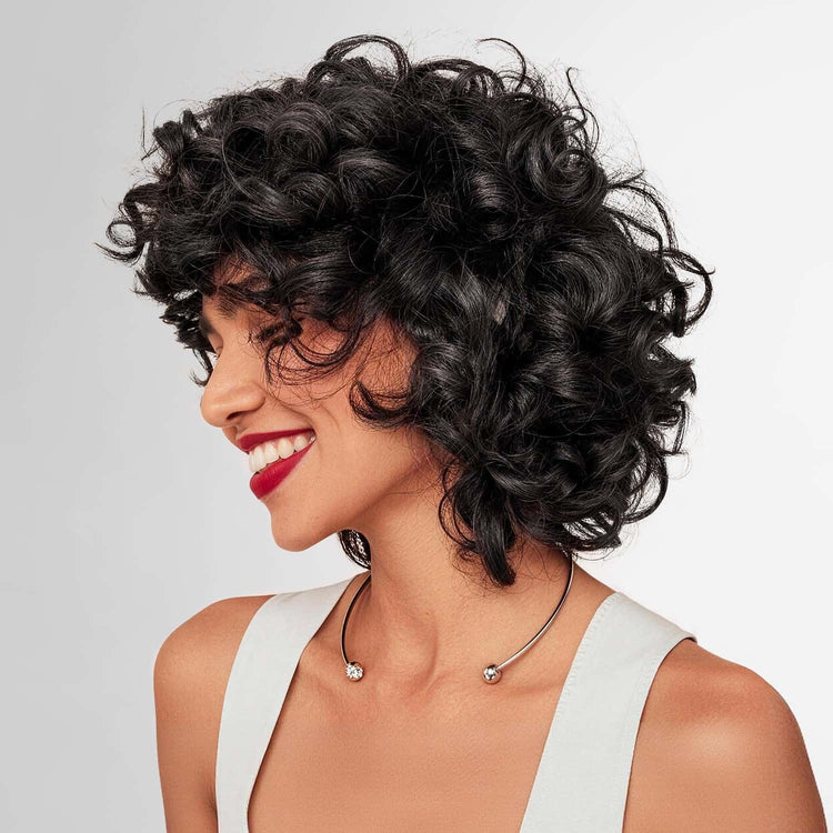 Natural black curly hair after 0% PPD hair dye shampoo, showing glossy curls, even color, and gray hair coverage results